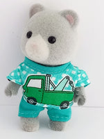 sylvanian families brothers shirt has white and jade green checks on the background,with a picture of a tow truck on the front. Plain jade green matching trousers.