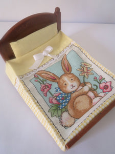 Sylvanian Double Bedspread Plain Matching Yellow Pillow,the bed spread has a cute picture of a rabbit holding a flower has yellow trims. 